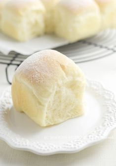 a white plate topped with rolls on top of a table