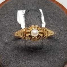 Vintage 14K Yellow Gold Art Deco Pearl Ring, Size 4.5. Not marked but tested positive as 14K. Pearl is 3.5mm. Ring is 7mm wide. Weighs 1.7 dwt. Are these stones real or fake? Aside from diamonds, we do not know if any gemstones are natural or synthetic. We will state on certain gemstones, that we know 100%, if they are created or fake due to their lack of inclusions. For this reason, we do not sell any diamonds without inclusions, and the larger diamonds (half ct+) are soft graded. In recent years, synthetic gemstones are being created to pass the hardness tests, which is why we state clear rubies and emeralds to be created.  In regards to Star Sapphires, typically, a genuine Star Sapphire's star will follow a light source that is shining on it, while created ones stay stationary. In recen Antique Yellow Gold Pearl Ring, Victorian 14k Yellow Gold Pearl Ring, Victorian Style 14k Yellow Gold Pearl Ring, Antique Yellow Gold 14k Pearl Ring, Antique 14k Stamped Pearl Ring Gift, Gold Antique Rings With Maker's Mark, Victorian Yellow Gold Pearl Ring Gift, Victorian 14k Gold Pearl Ring For Formal Occasions, Victorian Style Gold Pearl Ring For Formal Events