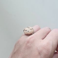 a person's hand with a cookie ring on it