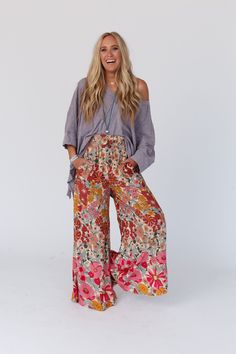 Groovy vibes only while wearing the Groovy Gardens Wide Leg Pant! Get ready for plenty of compliments while wearing these because they feature: Lightweight and flowy woven fabric with an eye - catching floral print throughout Loose and flowy wide leg silhouette High - rise smocked elastic waistline for a comfy fit Convenient side pockets Make a comfy statement in these by pairing with: Sophie Crochet Lace Bralette, Scoop Neck Bralette Tee, Kylie Studded Sandal *Due to lighting and differences in Casual Boho Print Pants For Vacation, Multicolor Wide Leg Pants With Floral Print, Multicolor Floral Print Wide Leg Pants, Casual Floral Print Bottoms For Fall, Spring Day Out Printed Wide Leg Pants, Summer Floral Print Wide-leg Bottoms, Multicolor Floral Print Wide Leg Bottoms, Casual Boho Print Pants, Bohemian Floral Print Bottoms For Spring