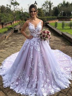 a woman in a purple wedding dress posing for the camera with her hands on her hips