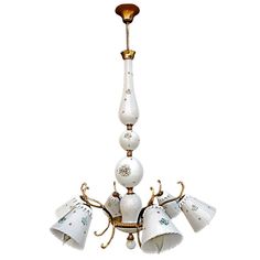 a white chandelier with five lights hanging from it's sides and four lamps on each side