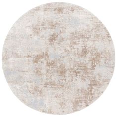 a round area rug with an old, faded design on the top and bottom half