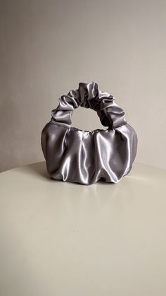 Silver evening bag made from smooth satin. Stylish designer woman bag is soft, but keeps its shape, closes with a magnetic button. Small satin bag is able to decorate not only official event, but also becomes a companion for every day. Perfect wedding bag. Scrunchies handbag consists of 3 layers: the outer material and the lining are satin, with a special seal between them so that the handbag keeps its shape. Small evening handbag can also be sewn from soft pleasant velvet. Material: Soft, pleas Elegant Gray Pouch Bag, Chic Satin Clutch Evening Bag, Chic Satin Finish Evening Bag For Party, Elegant Satin Evening Bag With Satin Finish, Chic Silver Pouch Evening Bag, Elegant Solid Color Evening Bag, Elegant Party Bag With Satin Finish, Chic Satin Bags With Satin Finish, Elegant Gray Bag For Gift