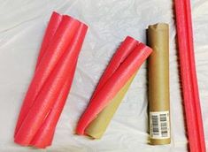 some red sticks are next to a roll of paper