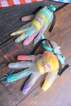 two plastic hand puppets sitting on top of a wooden table