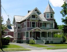 an old victorian style house on the corner of a street