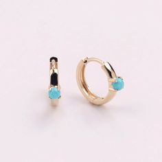 Handmade dainty mini hoop, made from 14kt solid yellow gold. Set a natural turquoise stone. Beautiful and don't be afraid it will tarnish when you are in the shower, on the beach, or in the sea! Great and classic for everyday style!! 9.5mm in height, 11.8mm wide. About 2.5mm turquoise. Size and color are slightly different. 6000-0008-1 Everyday 14k Gold Turquoise Jewelry, Everyday Turquoise 14k Gold Jewelry, Minimalist Turquoise Hoop Earrings For Gifts, Minimalist Turquoise Hoop Earrings As Gift, Minimalist Gold Huggie Earrings With Gemstone, Minimalist Yellow Gold Hoop Earrings With Gemstone, Turquoise Hoop Huggie Earrings As Gift, Turquoise Round Huggie Earrings For Gift, Turquoise Huggie Earrings For Gift