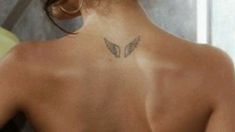 a woman with a butterfly tattoo on her back