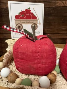 two red apples sitting on top of a table