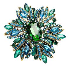 Looking for some bling to wear? This beautifully green/blue ring is guaranteed to finish off any Drag Queen look. The stones are set in a metal casing and with an elastic ring, it fits most hands. It measures 9.5cmx8cm Green Brooch For Party, Green Crystal Ring Metal Gift, Green Rhinestone Jewelry For Gift, Green Jeweled Brooch Gift, Green Jeweled Brooches For Gifts, Green Jeweled Round Ring, Green Round Brooch For Gift, Turquoise Party Ring, Green Round Brooches For Gift