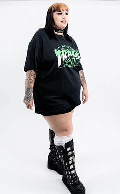 Show your allegiance in this rad oversized shirt designed exclusively for Tragic Beautiful by @brydiebrutal. Bringing us back to our emo roots with a hint of sk8r boi vibe thrown in too. Available in sizes XS-5XL. We have other sizes available here. These shirts are designed to be oversized for max comfort. Check the sizing chart for measurements or feel free to contact us for more assistance. Model is wearing a size 3XL. Made from high-quality fabric and screen printed with care. We produce ethically by building relationships with small businesses here and overseas that fit our ethical framework. Fabric: 50% cotton and 50% polyester which has a slight stretch for a flattering and comfortable fit. Care Instructions: Machine wash 30°c. Do not bleach. Do not tumble dry. Iron at low temperatu Occult Fashion, Scene Queens, Building Relationships, Green T Shirt, Green Tshirt, Oversized T Shirt, Oversized Shirt, Sizing Chart, Oversized Tshirt