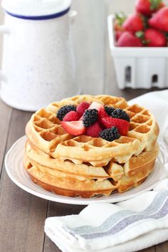 a stack of waffles with berries on top