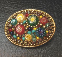 "Offered is a super nice combination brooch and pendant from Michal Golan. Millifiore glass with multi colors Measures 1.75\" x 1.25\" in diameter. Excellent vintage condition." Antique Multicolor Brooches As Gifts, Antique Multicolor Brooch For Gifts, Multicolor Cabochon Brooch As Gift, Multicolor Cabochon Brooch For Gift, Multicolor Cabochon Brooches As Gift, Multicolor Cabochon Brooches For Gifts, Multicolor Cabochon Brooches For Collectors, Vintage Multicolor Collectible Brooches, Unique Multicolor Collectible Brooches