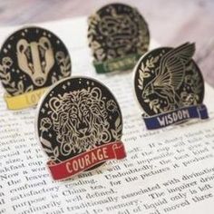 three badges are sitting on top of an open book