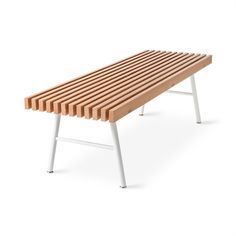 a wooden bench sitting on top of a white metal frame