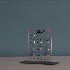 a desk calendar with the date on it and stars in the sky, sitting on top of a table