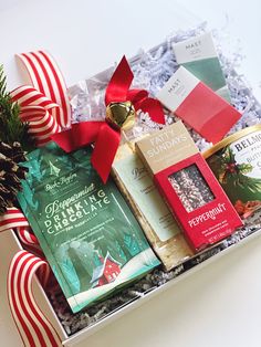 a christmas gift box filled with books, candy and other holiday treats for the holidays