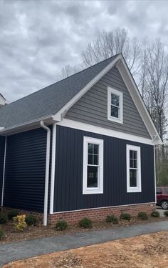 a blue house with white trim and windows