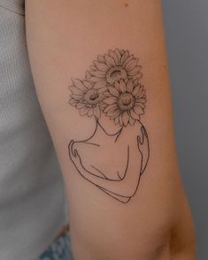 a woman's arm with a flower tattoo on the left side of her arm