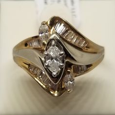 "Vintage 14K Yellow Gold Est 1 Tcw Diamond Ring, Size 7. Inside the band is marked © A66 14K. No missing stones. Weighs 4.1 dwt. We do not check prongs for wear or stones for looseness. All items are sold as is-noting that we are a resale shop so everything here had a previous owner! We will include flaws in the description when noted. This is one of the reasons our items are more affordable than new at a jewelry store. Are these stones real or fake? Aside from diamonds, we do not know if any ge Classic Diamond Cut Bypass Ring For Anniversary, Gold Bypass Ring With Diamond Cut For Anniversary, Gold Diamond Cut Bypass Ring For Anniversary, White Cluster Ring Stamped 14k For Anniversary, Stamped 14k Marquise Cut Ring For Anniversary, 14k Stamped Marquise Cut Ring For Anniversary, Marquise Cut White Gold Ring Stamped 14k, Vintage Wedding Jewelry, European Jewelry