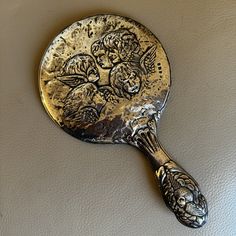 an antique spoon with some pictures on it