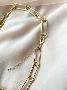 "18k gold plated over brass paper clip chain necklace. Large elongated rectangular link paper clip chain. This trendy oversized paper clip chain necklace is perfect for layering.  24mm x 7.5mm links  Gold plated Hook and eye closure clasp - makes putting your necklace on and taking it off simple.  Available in 16\", 18\", 20\"" Gold-tone Paperclip Bracelet With Lobster Clasp, Gold-tone Link Paperclip Bracelet With Cable Chain, Gold Paperclip Bracelet With Figaro Chain Links, Gold Metal Chain Necklace With Paperclip Chain, Gold Paperclip Bracelet With Adjustable Chain, Gold Paperclip Bracelet With Adjustable Chain And Rectangular Links, Gold Chain Necklace With Paperclip Design, Gold Paperclip Chain Link Bracelet, Gold Rectangular Paperclip Bracelet With Lobster Clasp