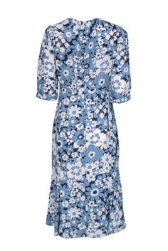 Bloom like a flower in this gorgeous blue midi dress from the Michael Kors Collection. This dress features fresh blooms in beautiful blue hues and is made from 100% silk, giving it a soft, feminine feel. An extra long tassel tie accentuates the flattering v-neckline of this piece, adding a playful vibe at your next brunch or weekend outing. Style with a pair of white mules and a patent leather crossbody for a chic look! Size 8 100% Silk Made in Italy Fully lines Invisible back zipper V- neckline Casual Silk Dress With Floral Print, Chic Blue Floral Midi Dress, Chic Blue Midi Floral Dress, Feminine Blue Silk Dress, Blue Midi Floral Dress, Blue Floral Print Midi Dress, Blue Floral Print Feminine Dress, Spring Silk Floral Midi Dress, Silk Floral Midi Dress For Spring