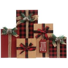 christmas presents wrapped in red and black plaid paper with the word joy written on them