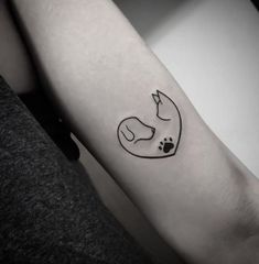 a small fox and paw tattoo on the arm