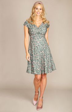 Our Alessandra maternity dress is a trusted favourite Tiffany Rose design. Now introducing our summer sage-green ditsy floral print. Breastfeeding friendly cross-over neckline, grown-on sleeves for that extra upper arm coverage and a full swishy skirt that falls to the knee. This maternity style is perfect for every event, from brunch with friends to wedding guest chic. Ditsy floral print in olive/sage green with flecks of orange and pink detail Soft premium stretch jersey fabric / Cross-over ne Spring Maternity V-neck Dress Nursing Friendly, Fitted V-neck Maternity Dress With Floral Print, Green Short Sleeve Maternity Dress, Green Short Sleeve Maternity Dress For Summer, Fitted Green Maternity Dress With Short Sleeves, Casual Green Maternity Dress, Green Summer Maternity Dress, Green V-neck Maternity Dress, Green V-neck Maternity Dress For Summer