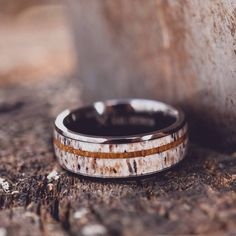 a wedding band that has been made to look like an antelope in the woods