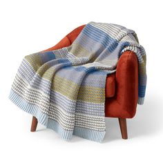 an orange chair with a blanket on it