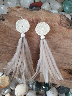 Coil Woven & Emu feather earrings. The coil is made with cream coloured 0.5mm waxed string. Adjustable White Feather Jewelry, Handmade Bohemian Cream Earrings, White Feather Dangle Earrings, Handmade Cream Bohemian Earrings, Handmade Cream Earrings For Beach, Cream Bohemian Earrings As A Gift, Cream Bohemian Earrings As Gift, Cream Bohemian Earrings For The Beach, Cream Bohemian Earrings For Summer