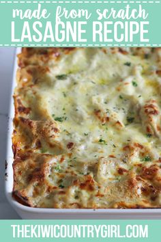 a casserole dish with cheese and meat in it on a white table top