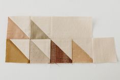 four pieces of fabric laid out on top of each other with different colors and shapes