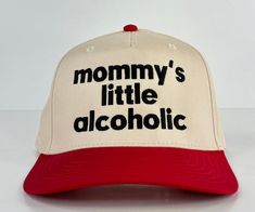 a red and white hat with the words mommy's little alcoholic written on it