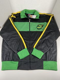 Jamaica Track Top Jacket ZIP Up High Quality. Full Zipper Jacket with Two (2) Pockets. Made with high quality, breathable fabric water Resistant and Machine Washable. 65% polyester 35% cotton. This sports Jacket or Top is perfect for layering up when heading off to the gym, or wearing something stylish when dressing casually. Crafted with a lightweight, breathable material, this Jacket is the perfect compliment to any activewear wardrobe. It comes with two pockets and a full zip front for a secu Cotton Long Sleeve Tracksuit For Gym, Black Cotton Windbreaker For Sports, Hooded Cotton Outerwear For Sports Events, Cotton Hooded Outerwear For Sports Events, Moisture-wicking Cotton Outerwear For Fall, Fall Cotton Outerwear With Moisture-wicking, Fall Moisture-wicking Cotton Outerwear, Black Cotton Track Jacket For Outdoor, Black Cotton Outdoor Track Jacket