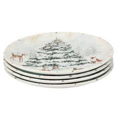 set of four christmas tree plates with deers and trees painted on the front in white