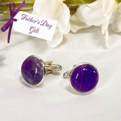 These beautiful cufflinks feature polished natural raw Amethyst cabochons and are perfect for a Father's Day Gift. Set in silver plated settings. Approximate diameter 16mm. Maybe add a match Amethyst Key Ring or Key Fob for something a bit extra... These cabochons are natural products so each amethyst cufflinks set will be unique and variations will occur. Boxed in a luxury box with magnetic closure. All of our jewellery boxes are eco friendly and FSC certified. See our complete range of Amethys Father's Day Round Jewelry With Polished Finish, Oval Polished Cufflinks For Gift, Oval Polished Finish Cufflinks For Gift, Adjustable Cufflinks As Gift, Adjustable Formal Jewelry For Father's Day, Classic Polished Gemstones For Gift, Classic Handmade Gemstones For Gifts, Handmade Classic Gemstones For Gifts, Classic Polished Gemstones For Gifts