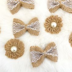 six burlap bows with pearls on them sitting on a white furnishing