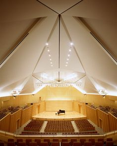 an empty auditorium with rows of seats and lights