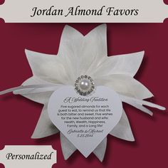 a wedding congratulations card with a white flower and pearl brooch on it's side