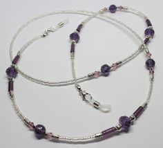 "A lovely glasses chain made using purple tones crystal and glass beads. The glasses chain measures approximately 28\" in length and is finished with rubber ends to securely attach your reading glasses or sunglasses. Very striking and beautiful chain. Lovely gift idea. Wrapped in tissue paper and presented in an organza pouch." Adjustable Glass Gemstone Beads, Purple Glass Beaded Necklaces With Round Beads, Purple Glass Beaded Necklace With Round Beads, Adjustable Purple Glass Glasses Chains, Purple Adjustable Crystal Necklaces With Faceted Beads, Handmade Purple Glass Beaded Necklaces, Adjustable Purple Glass Beaded Necklaces, Adjustable Single Strand Glass Crystal Necklace, Purple Glass Glasses Chains As Gift