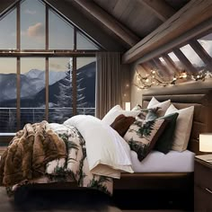 a bedroom with a large window overlooking the mountains and snow capped peaks is pictured in this image