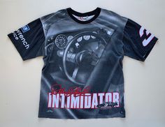 "Original vintage 90s Dale Earnhardt The Intimidator all over print graphic NASCAR tshirt.  ERA: 1990s TAG: Chase Authentics, Nutmeg Mills, Made in USA FABRIC: 100% Cotton CONDITION: Excellent, may show minor signs of wear but no major issues (like stains/tears) APPROX SIZE: extra large -MEASUREMENTS- Across chest, pit to pit and doubled: 50\" Length (shoulder to hem): 30\" *If package is marked delivered by the carrier, but you didn't receive it, you must report it to the carrier for them to investigate/try to re-deliver. All items I ship are insured. I do this for your benefit so you have a remedy for items lost/damaged in shipping.  *My items are used vintage and should expect to show signs of normal wear and commonly will have faint marks/discoloration or imperfections. I do my best to Vintage Short Sleeve Top With All Over Print, Vintage Short Sleeve T-shirt With All Over Print, Vintage All Over Print T-shirt For Streetwear, Vintage All-over Print T-shirt For Streetwear, Vintage All Over Print Streetwear Tops, Vintage All Over Print Tops For Streetwear, 90s Short Sleeve Tops With All Over Print, Vintage All-over Print Tops For Streetwear, But You Didnt