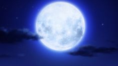 the full moon is shining brightly in the night sky, with clouds and stars around it