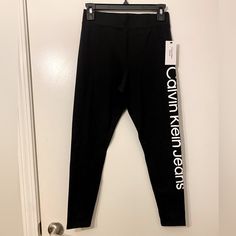 Calvin Klein Leggings. Size Small. Black With White Letters Down The Leg. Brand New. Casual Stretch Calvin Klein Bottoms, Calvin Klein Stretch Bottoms For Spring, Calvin Klein Stretch Casual Bottoms, Calvin Klein Casual Stretch Bottoms, Spring Stretch Bottoms By Calvin Klein, Trendy Fitted Calvin Klein Bottoms, Casual Fitted Calvin Klein Activewear, Calvin Klein Stretch Bottoms, Calvin Klein Stretch Elastane Bottoms