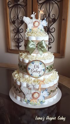 a three tiered baby shower cake on a table