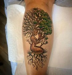 a woman with a tree tattoo on her leg